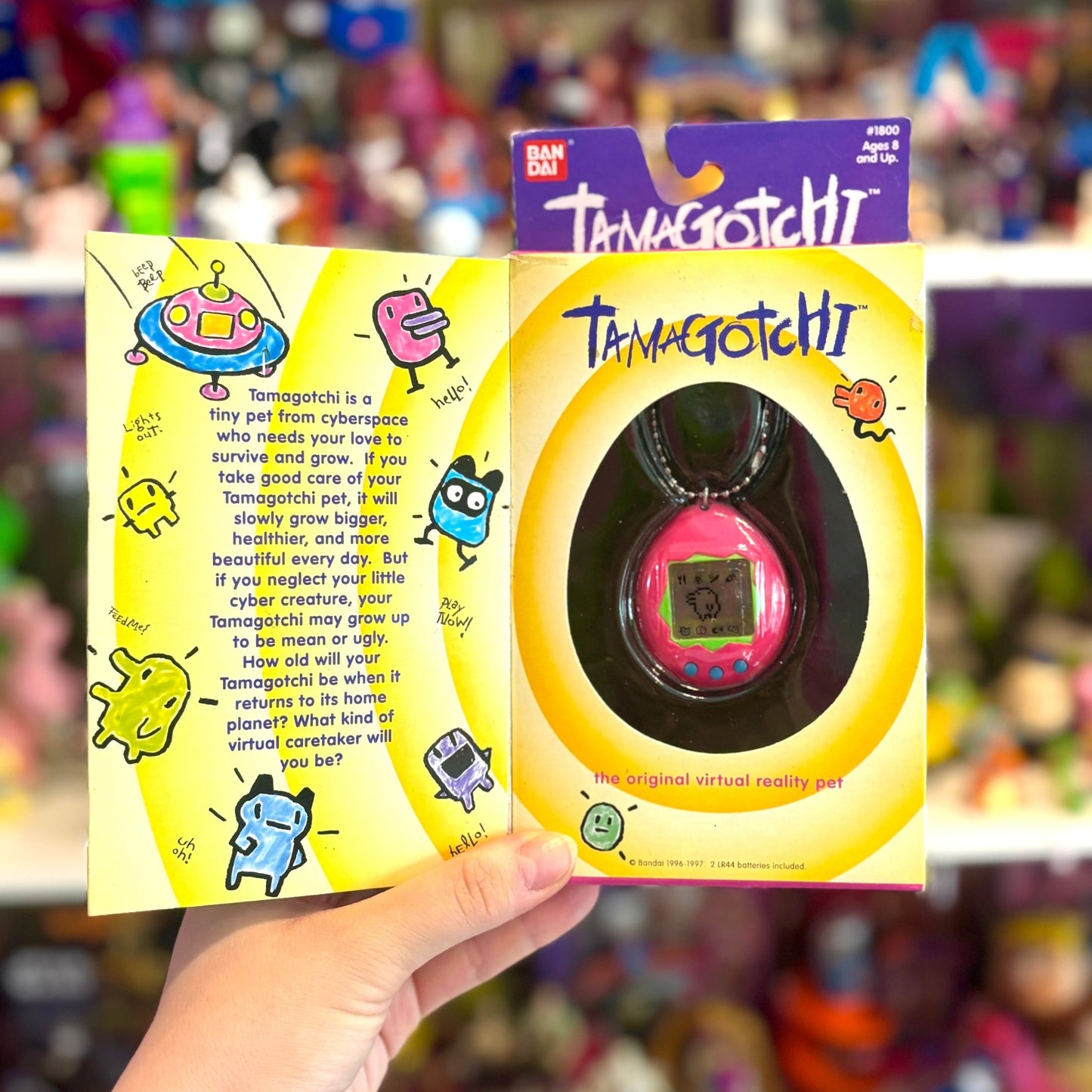 Tamagotchi Gen 1 - Pink Shell with Green and Blue Details (1997, Bandai) - PopCultGang